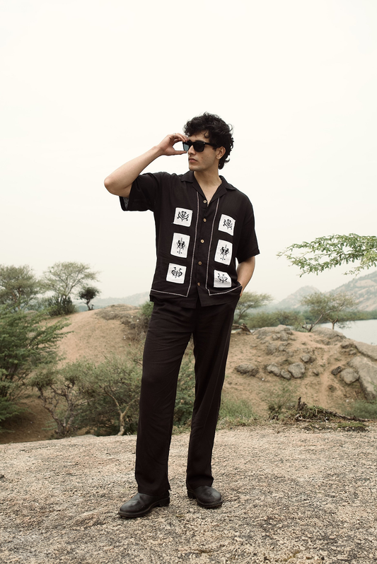 Black drawstring pants with a straight-leg fit and elastic waistband