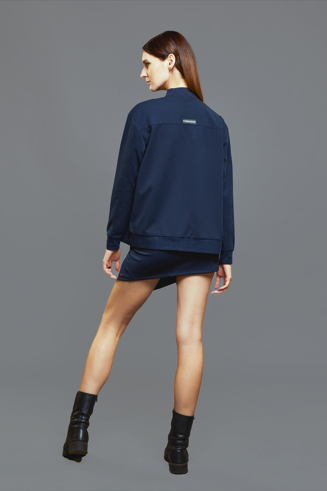 a man in a blue shirt and a black backpack