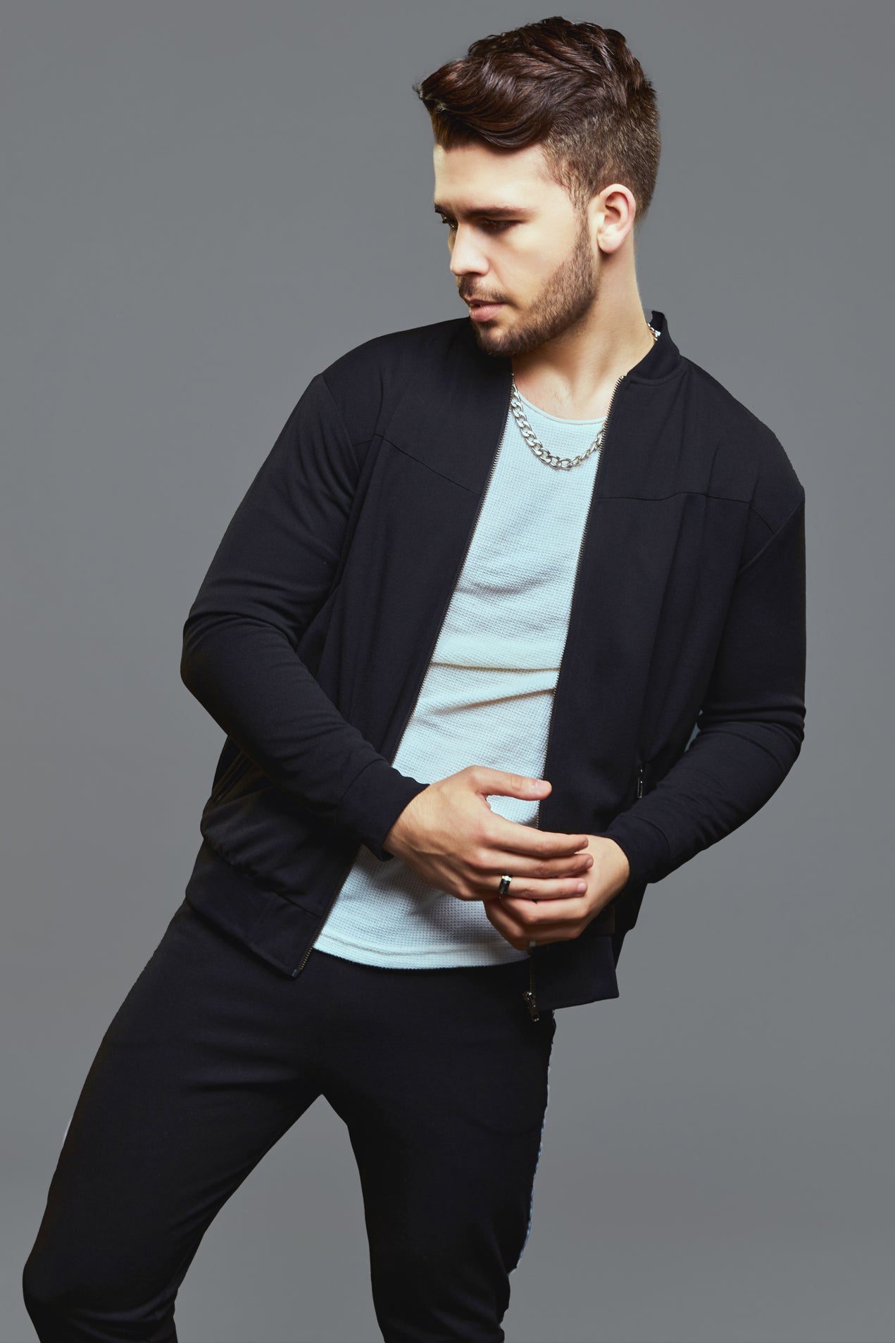 a woman standing next to a man holding a cell phone