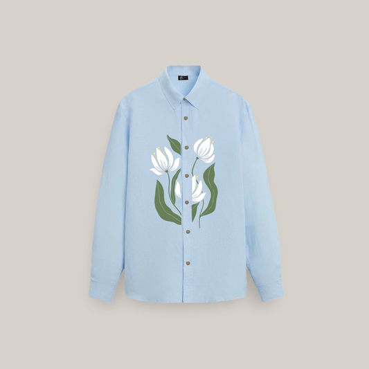 Light blue long-sleeve button-up shirt with an oversized fit, featuring a large floral graphic of white flowers with green stems and leaves printed on the front