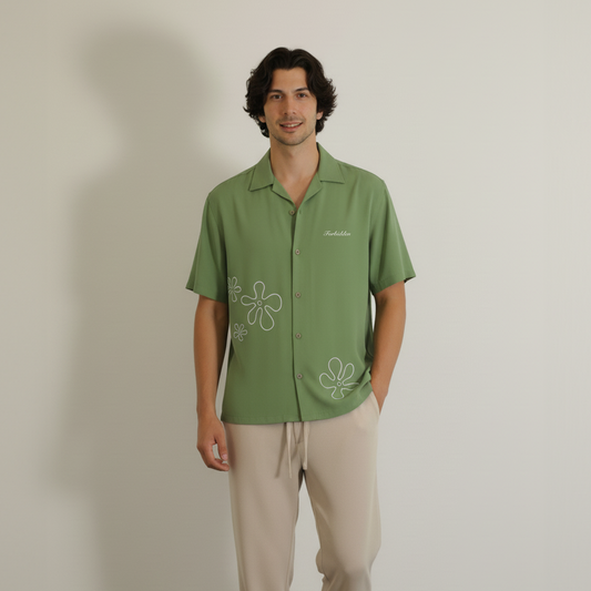 A floral-patterned green shirt featuring various colorful flowers, perfect for a casual look.