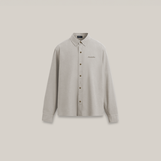 Beige button-up shirt with long sleeves and a classic collar set against a light background.