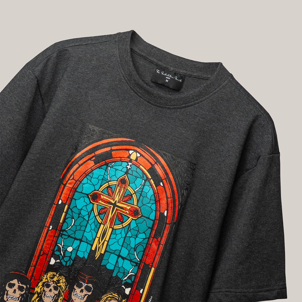 The centerpiece of this design is a stunning stained glass effect depicting the solemn yet mesmerizing image of a church door, symbolic of the journey between worlds. Below it, five skulls emerge, representing the band members themselves, immortalized in the annals of rock history.
FABRIC – 240 GSM 100% Terry cotton - Black & Grey Blended Mélange fabric