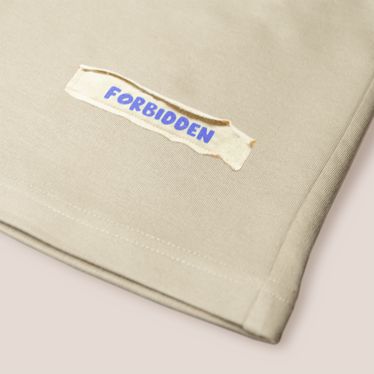 Beige shorts featuring the phrase "the best" prominently displayed on the front.