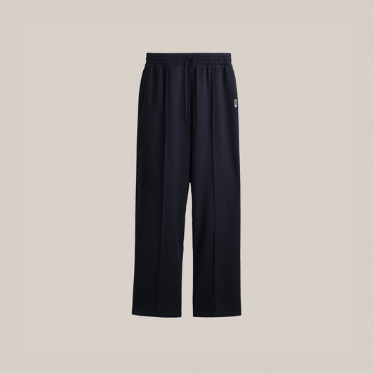 “Navy blue wide-leg pants with an elastic drawstring waistband and a small square logo on the upper left side.”