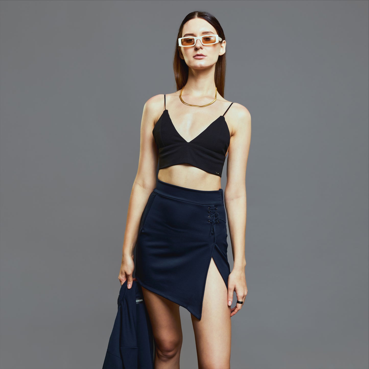 a woman in a skirt holding a tennis racquet