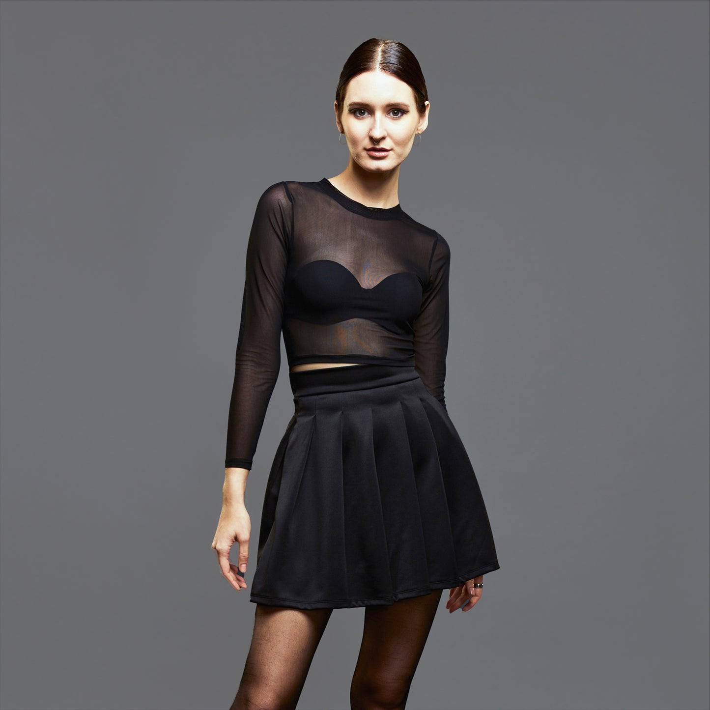 a woman in a black dress holding a purse