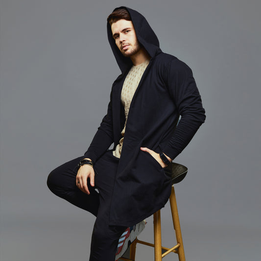 a woman in a black coat standing on a ski slope