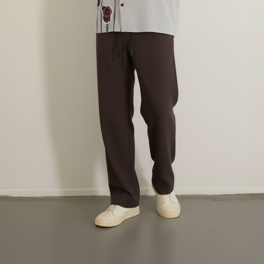 Loose dark brown drawstring pants worn