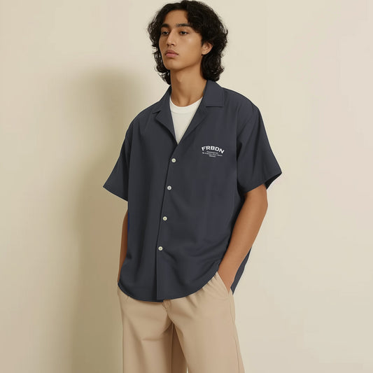 a man standing in front of a white wall