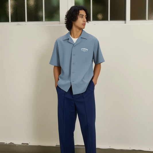 a man standing in front of a white wall