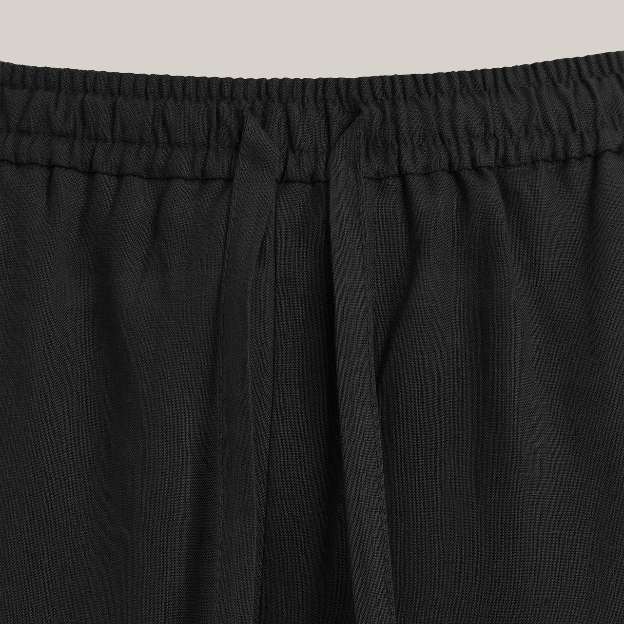 Black drawstring pants with a straight-leg fit and elastic waistband