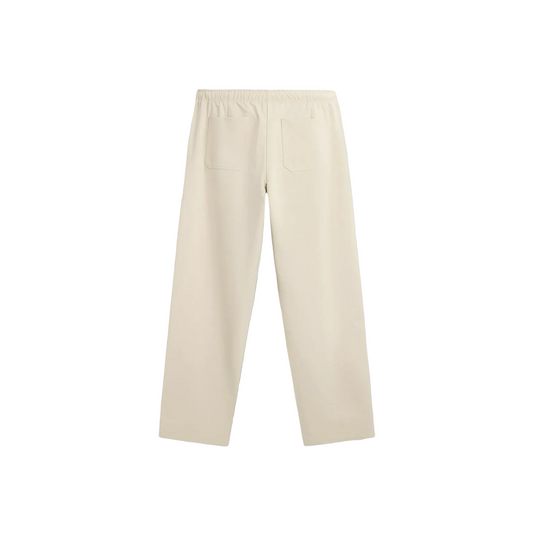 Cream-colored straight-leg pants with an elastic waistband and pink “forbidden” text on the upper left side, featuring floral prints with pink blossoms, green leaves, and black dots near the bottom of both legs.