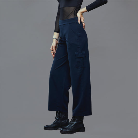 a man standing on a street holding a skateboard