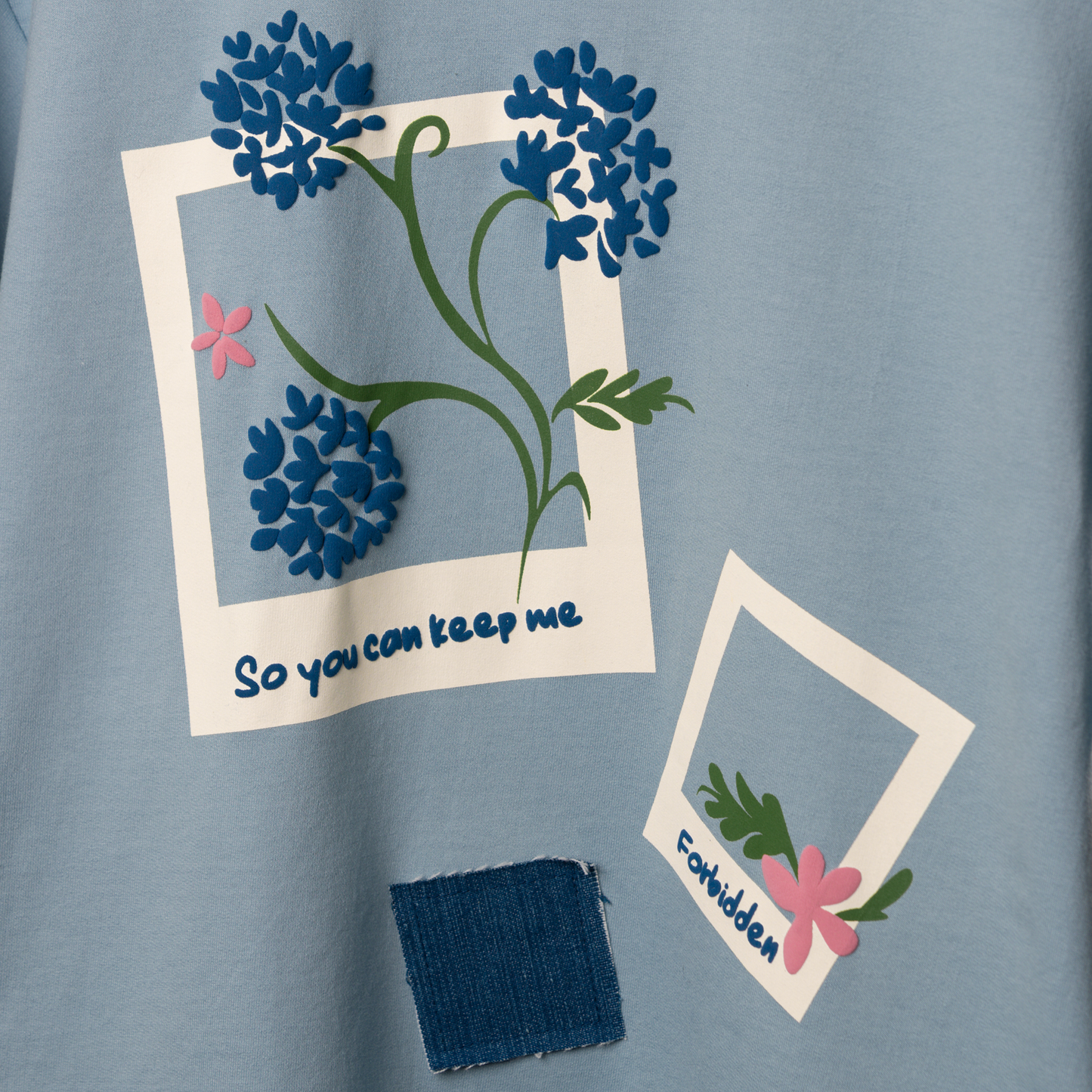 Front polaroids and back denim pocket patch cleverly illustrate the lyrics "so you can keep me in the pocket of your ripped jeans." Hand-printed with puffed detailing for a textured, elevated appeal. Light blue color and floral accents make it effortlessly charming and versatile - Perfect for your concert look!
FABRIC – 260 GSM Cotton Terry Fabric