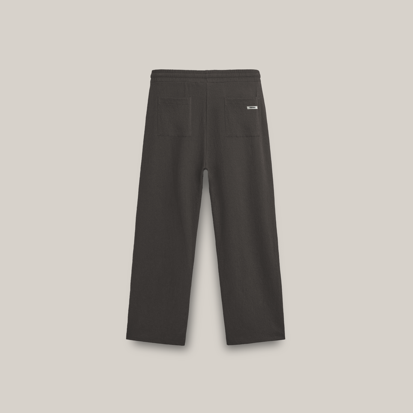 wide-leg pants with an elastic waistband, drawstring, and a small square logo on the upper left side