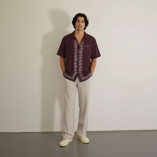 Maroon shirt with stylish embroidered accents, showcasing detailed craftsmanship.