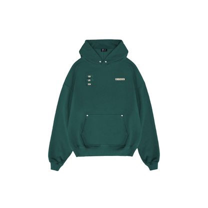 Dark green hoodie shown from the back featuring bold “FORBIDDEN” text, a small “For the Few” label, and a minimalist inspirational slogan printed at the center.