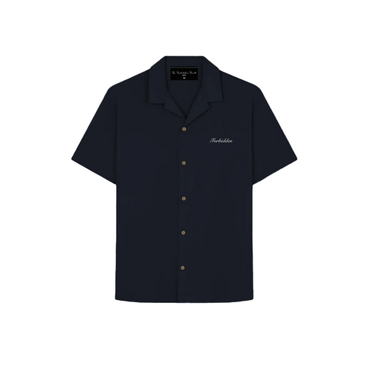 A plain navy-blue short-sleeve Cuban-collar shirt laid flat The shirt has a relaxed fit, soft fabric texture, and a button-down front, shown without any patterns or graphics.