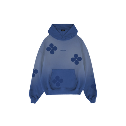 Front view of a blue gradient hoodie featuring darker blue floral motifs across the chest, sleeves, and pocket, with a kangaroo pocket, ribbed cuffs and hem, and subtle “Forbidden” text near the chest, shown against a neutral background.