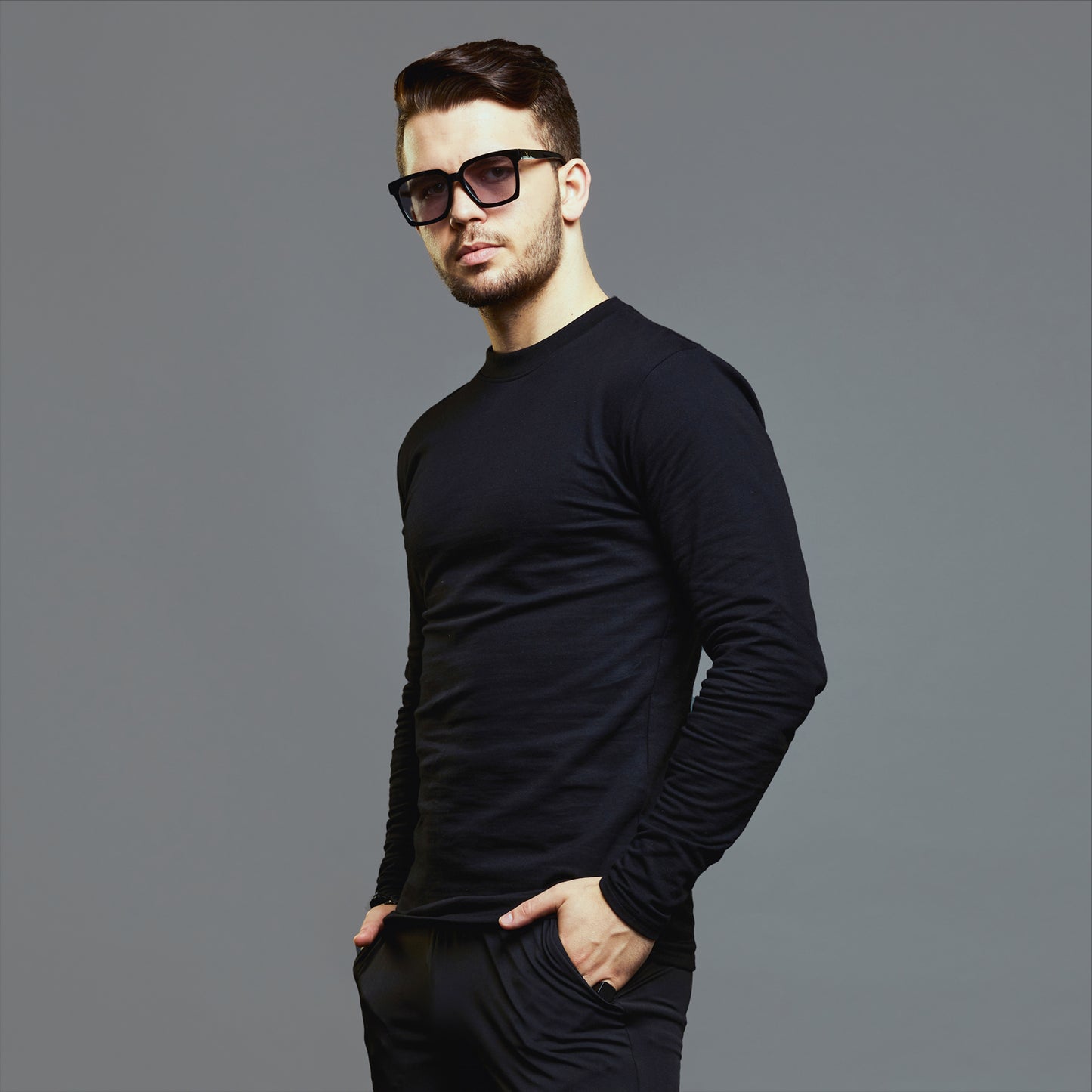 a man wearing a black shirt and sunglasses 