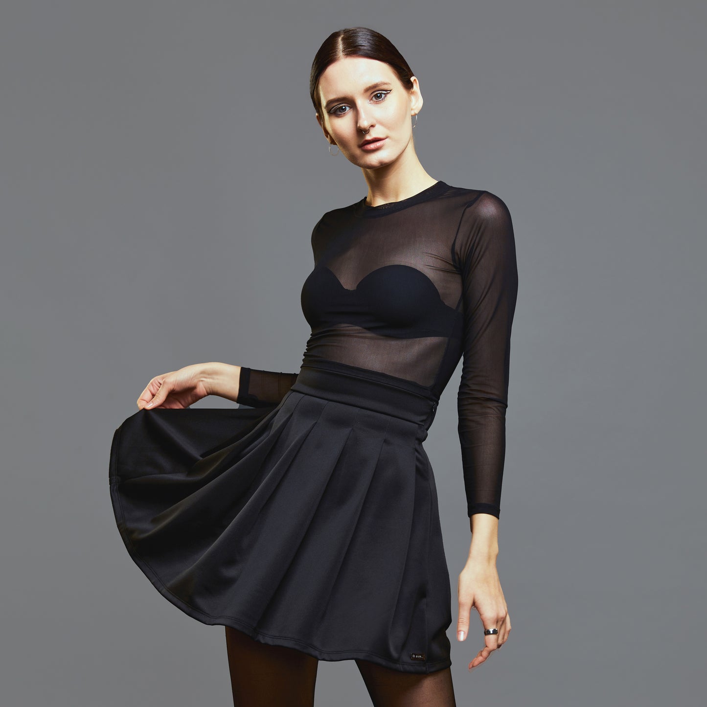 a woman in a black dress holding a tennis racquet 