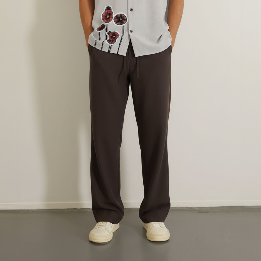 Loose dark brown drawstring pants worn 