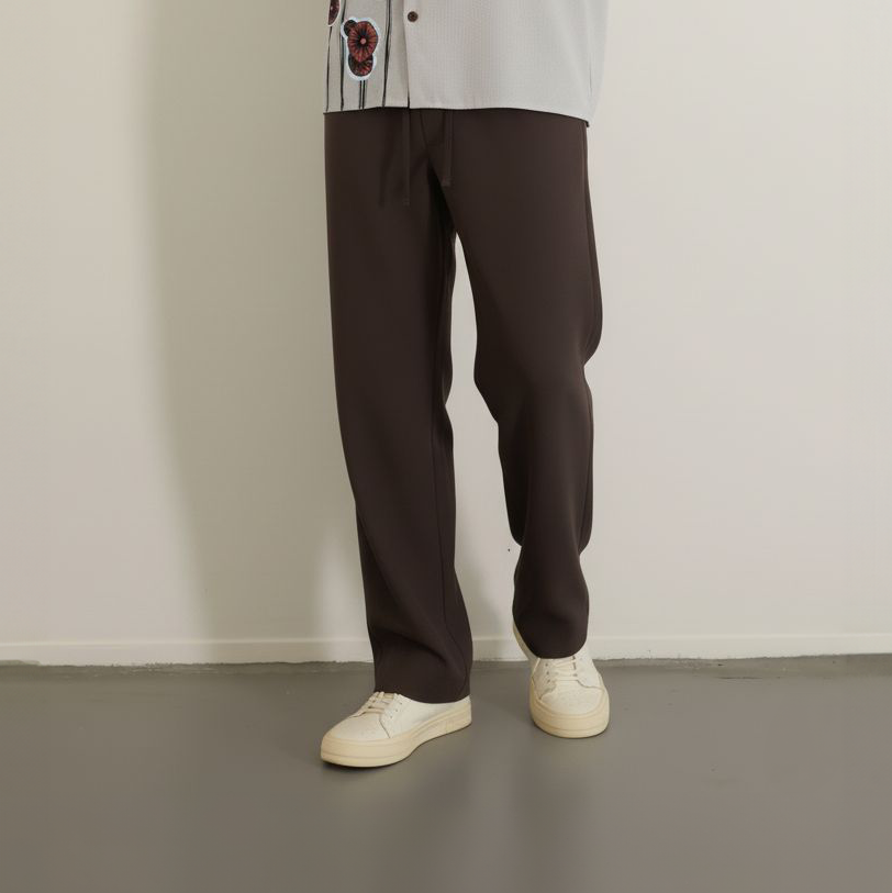 Loose dark brown drawstring pants worn 