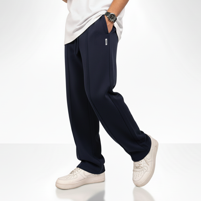 “Navy blue wide-leg pants with an elastic drawstring waistband and a small square logo on the upper left side.”