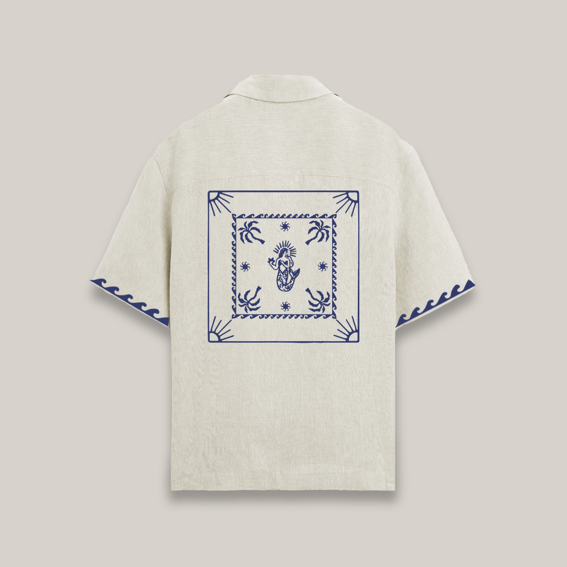 Beige shirt with blue embroidery on a light gray background