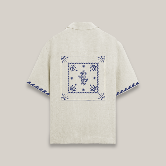 Beige shirt with blue embroidery on a light gray background