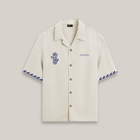 Beige shirt with blue embroidery on a light gray background
