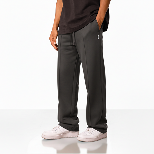 wide-leg pants with an elastic waistband, drawstring, and a small square logo on the upper left side