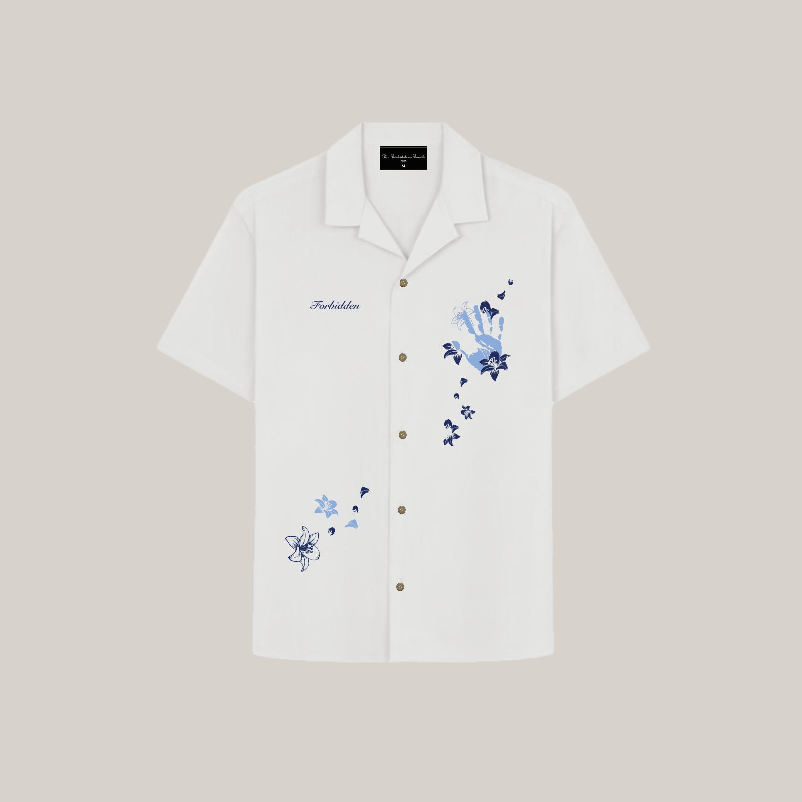 The design includes layered flowers, petals, and small decorative elements in varying shades of blue. The word "Forbidden" is embroidered on the left chest in a small script font. The buttons are metallic or bronze-toned, adding a subtle contrast to the clean white shirt. The overall aesthetic is elegant, artistic, and slightly whimsical.